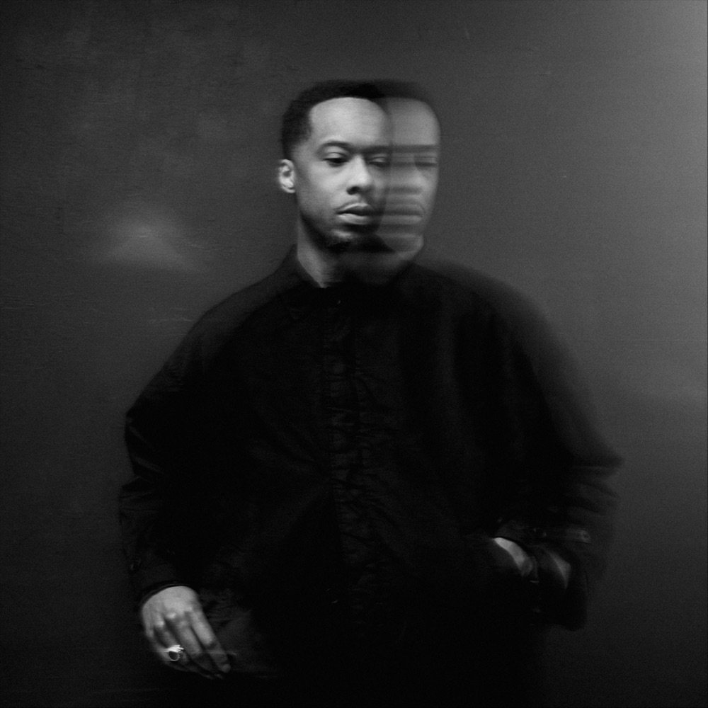 CEREMONIAL album cover: black and white photo of Black Milk in dark clothes, his face doubled by motion blur