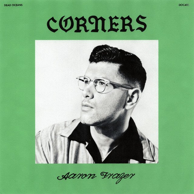 Corners EP cover: a black and white portrait of Aaron Frazer in glasses inside a green frame, with CORNERS in gothic letters