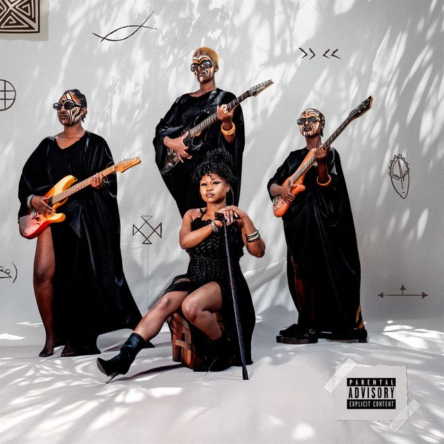 Nu Zamrock album cover: Sampa the Great sitting with a cane among three masked musicians holding electric guitars, in a white room with chalk symbols on the wall